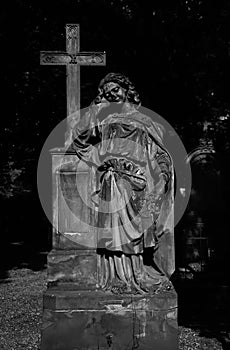 Marble statue angel with cross statue in Olsany Cemetery in Prague