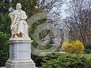 Marble statue of the austrian poet and writer Robert Hamerling sitting in a chair in the city park Stadtpark, in Graz, Steiermark