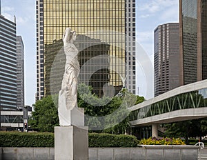 Marble statue of a classic female figure by Marton Varo in front of the Plaza of the Americas