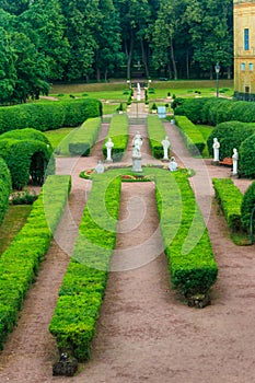 Marble statue of the goddess Flora surrounded by marble bacchantes and satyrs in Private Garden of Gatchina palace, Russia