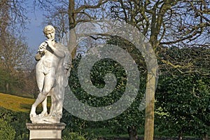 The Marble Statue of the Naked God Pan Playing a Flute in the Queens Garden Behind Kew Palace at the Royal Botanical Gardens, Kew