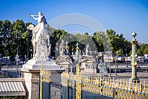 Marble statue and the Tuileries Garden entrance gate, Paris