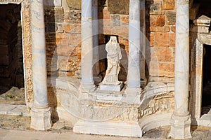 Marble statues at the columns of the amphitheater in Hierapolis, Turkey