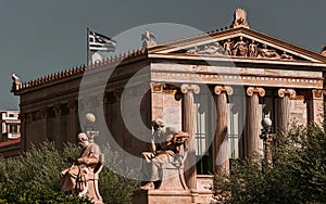 Marble statues of Plato and Socrates, the ancient philosophers, in front of the neoclassical building of the National Academy.