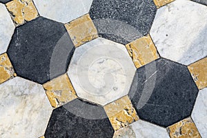 Black grey and yellow marble tiled floor pattern