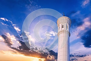 marble white minaret of new Minor Mosque in Tashkent in Uzbekistan on background of beautiful blue sunset sky