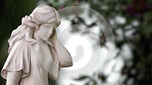 Marble woman sculpture under rain