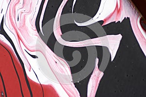 Marbled acrylic colored pattern in the colors red, black, white and pink