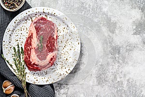 Marbled beef fillet steak. Raw rib eye, ribeye. gray background. top view. Copy space