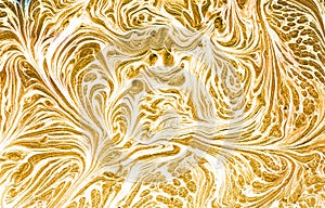 Marbled blue abstract background with golden sequins. Liquid marble ink pattern.