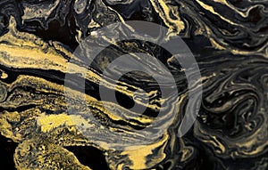 Marbled blue abstract background with golden sequins. Liquid marble ink pattern. Effect, paint.
