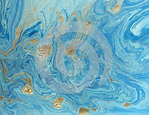 Marbled blue and golden abstract background. Liquid marble pattern