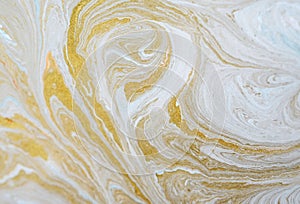 Marbled blue and golden abstract background. Liquid marble pattern. Paper, color.