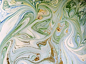 Marbled blue, green and gold abstract background. Liquid marble pattern.