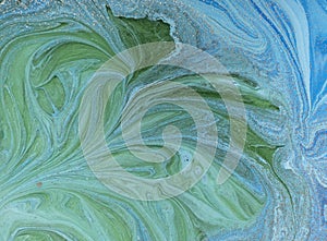 Marbled blue, green and golden abstract background. Liquid marble pattern