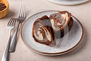 Marbled bundt cake sliced on a plate, chocolate and vanilla marble cake with chocolate glaze