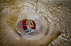 A marbled and colorful stone in the gray water with background and white rippled water