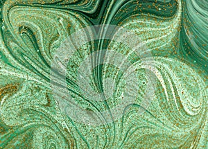 Marbled green abstract background with golden sequins. Liquid marble ink pattern.