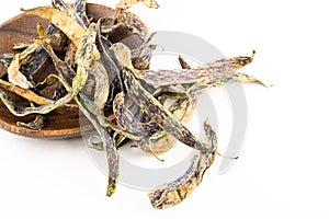 Marbled green purple bean pods in wooden bowl on isolated background