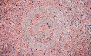 Marbled pattern of a smooth red stone slab