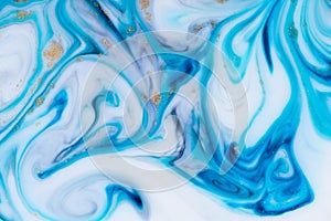 Marbling unique blue abstract background with gold dust