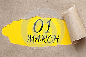 march 01. 01th day of the month, calendar date. Hole in paper with edges torn off. Yellow background is visible through