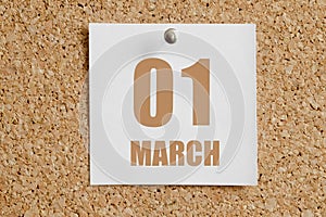 march 01. 01th day of the month, calendar date. White calendar sheet attached to brown cork board.Spring month, day of