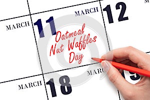 March 11. Hand writing text Oatmeal Nut Waffles Day on calendar date. Save the date.