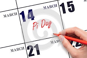 March 14. Hand writing text Pi Day on calendar date. Save the date.