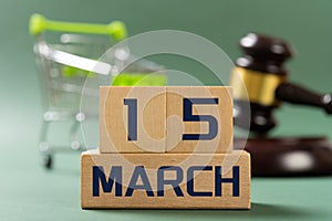 MARCH 15 in front and shopping cart & judge gavel on back concept of world consumer rights day