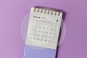 March 2024. Desktop calendar for March 2024 on a lilac background with a space to copy