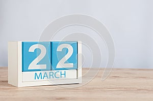 March 22nd. Day 22 of month, wooden color calendar on table background. Spring time, empty space for text