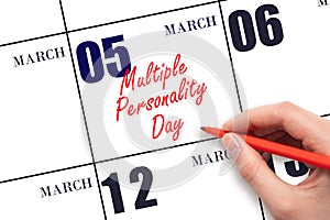 March 5. Hand writing text Multiple Personality Day on calendar date. Save the date.