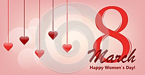 March 8 greeting card. Hanging red hearts on gentle pink background with lettering.