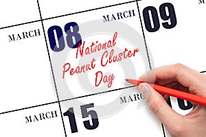 March 8. Hand writing text National Peanut Cluster Day on calendar date. Save the date.