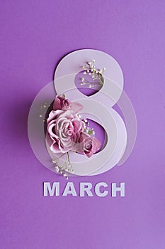 march 8 international women\'s day. violet roses with paper letters