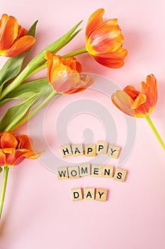 March 8, postcard. Happy Women\'s Day text sign on orange tulips background.