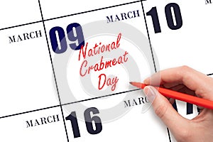 March 9. Hand writing text National Crabmeat Day on calendar date. Save the date.