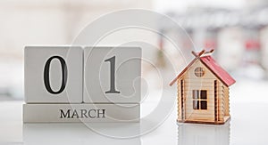 March calendar and toy home. Day 1 of month. Ð¡ard message for print or remember