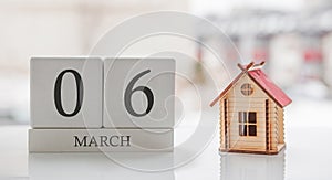 March calendar and toy home. Day 6 of month. Ð¡ard message for print or remember