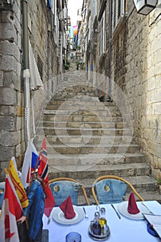 Dubrovnick-croazia-Outdoor tables in a street of fortified town of dubrovnik in croatia photo