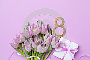 8 March. International Women's Day greeting card. Gift box and heap of fresh beautiful tulip flowers