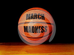 March Madness basketball on a hardwood court, college basketball tournament concept photo