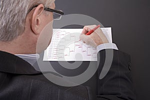 March Madness Businessman Crossing Out Teams on Bracket