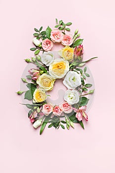March 8th concept. Creative layout made of colorful rose flowers on pink background. Greeting Card Women`s Day on March 8th