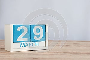 March 29th. Day 29 of month, wooden color calendar on table background. Spring time, empty space for text photo