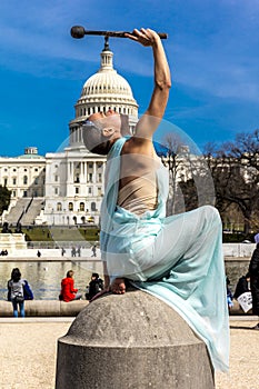 MARCH 24, 2018 - Washington DC, Female poses like Statue of Liberty in front of US Capitol,. Statue, Symbols