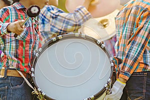 Marching band bass drummers perform in school