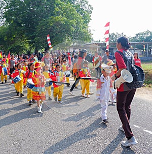Marching Band Of Elementary School Students With Colorful Costumes