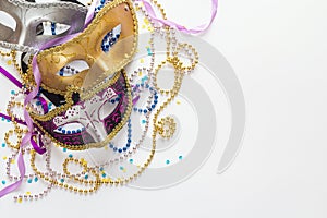 Mardi Gras background with masks, beads and copy space.